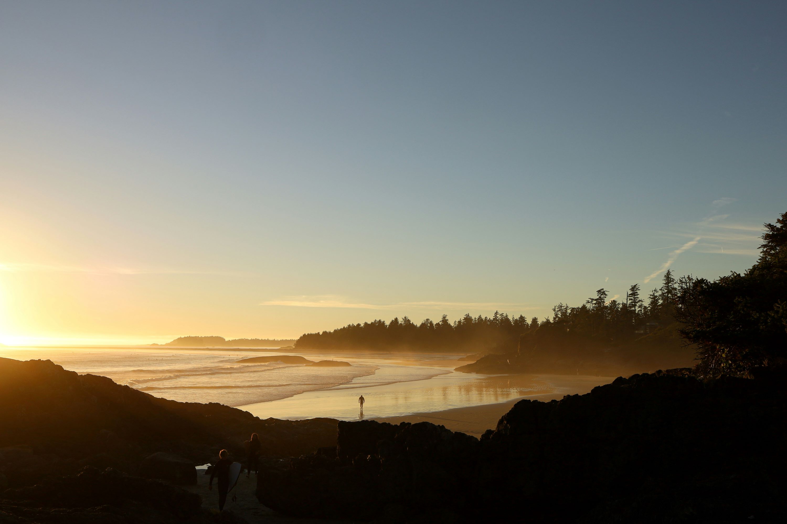 Wide shot of a person standing on the beach (Tofino, BC)