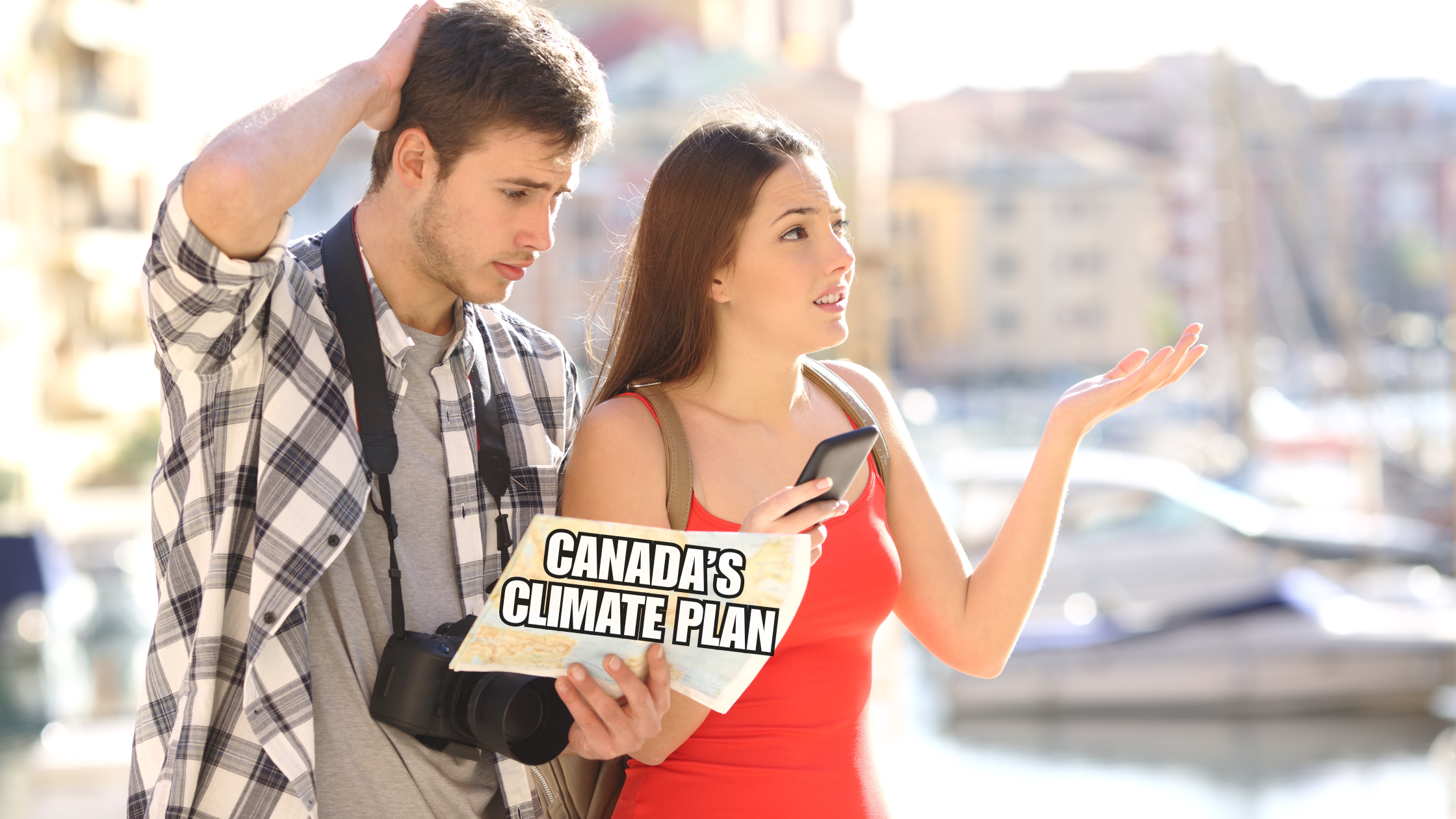 Couple in city stares at map with confused looks on their faces