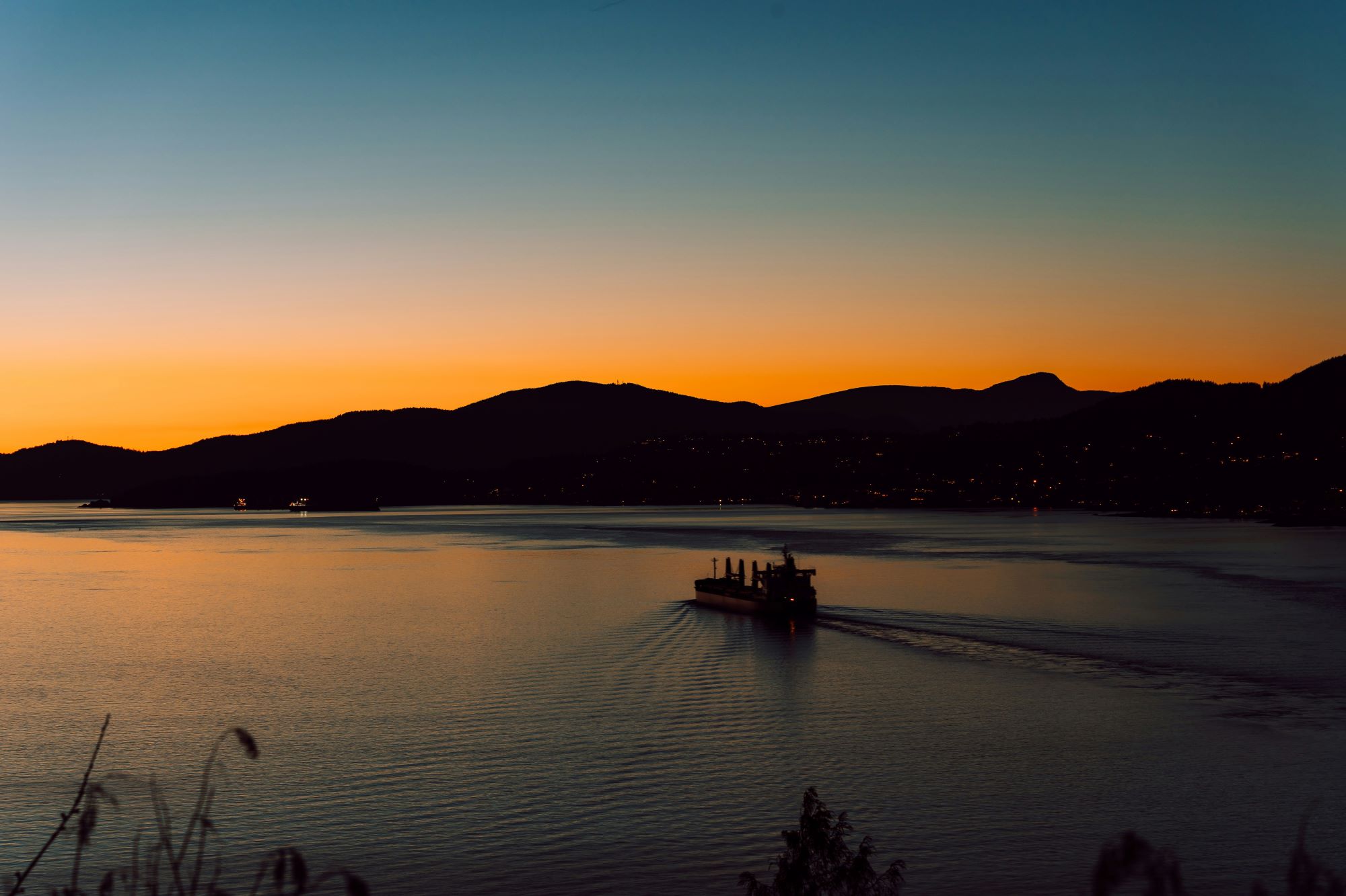 a boat traveling across a large body of water (Vancouver, BC)