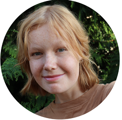 Selfie photo of plaintiff Sadie smiling while posing in front of greenery
