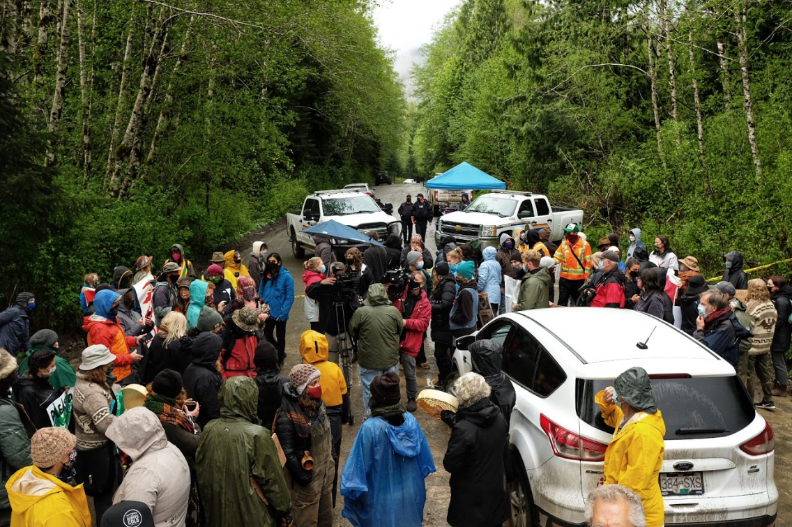 Close to a hundred people pushed an RCMP exclusion zone at Caycuse. Led by Indigenous matriarchs/elders, they occupied the checkpoint. When RCMP called for backup, around 10 people were arrested, including at least two Indigenous youth. During those arrests, media and bystanders were corralled away from the arrests and threatened with arrest if they returned. (Photo and context provided by Mike Graeme) Close to a hundred people pushed an RCMP exclusion zone at Caycuse. Led by Indigenous matriarchs/elders, they occupied the checkpoint. When RCMP called for backup, around 10 people were arrested, including at least two Indigenous youth. During those arrests, media and bystanders were corralled away from the arrests and threatened with arrest if they returned. (Photo and context provided by Mike Graeme)