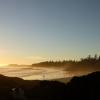 Wide shot of a person standing on the beach (Tofino, BC)