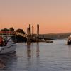 Sport fishing boats heading out on the water next to docks at sunrise